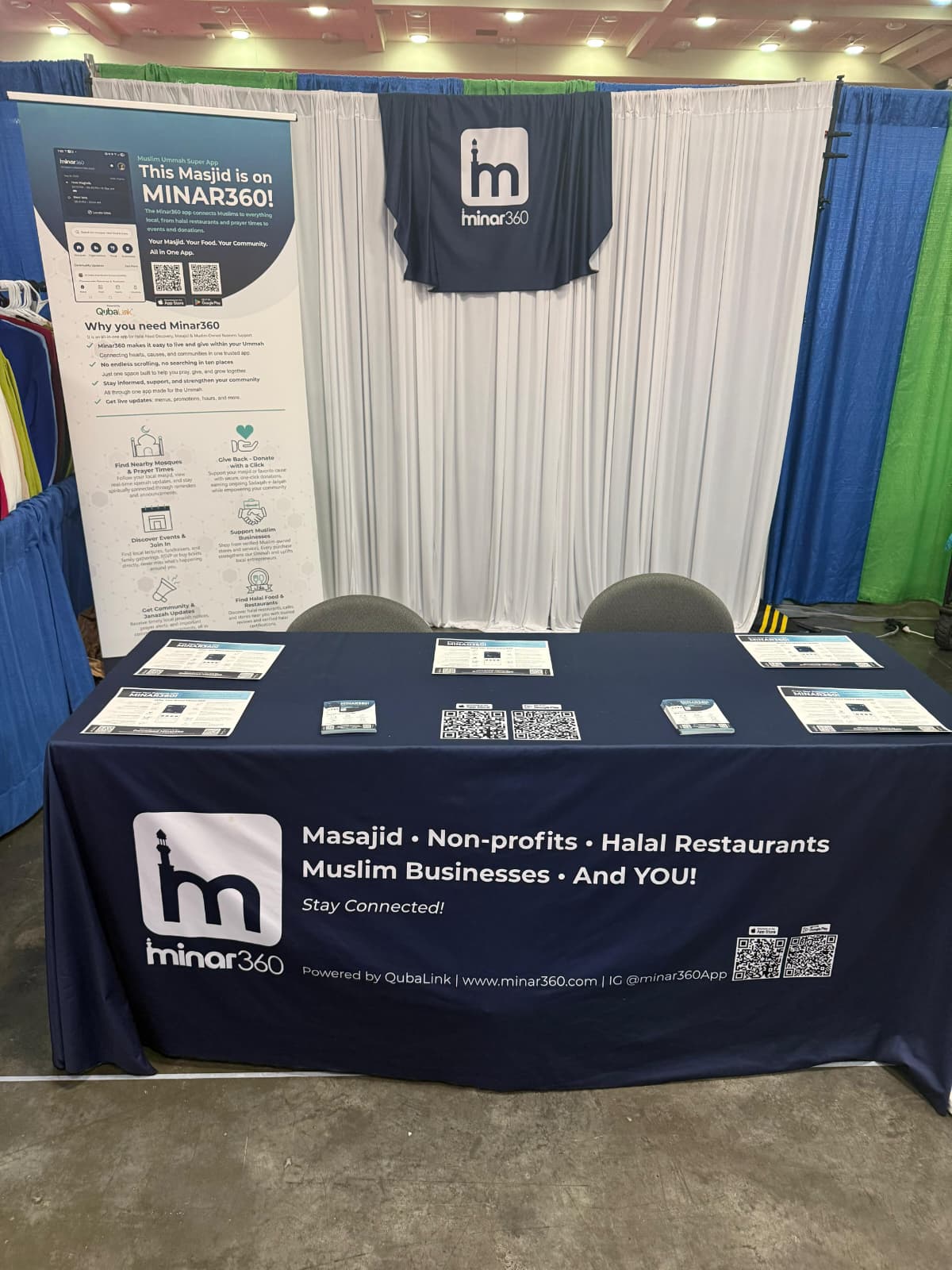 The Minar360 table and banner set up at a community convention